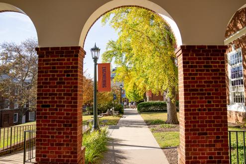 View through Darden arcade arches toward Olsson Hall