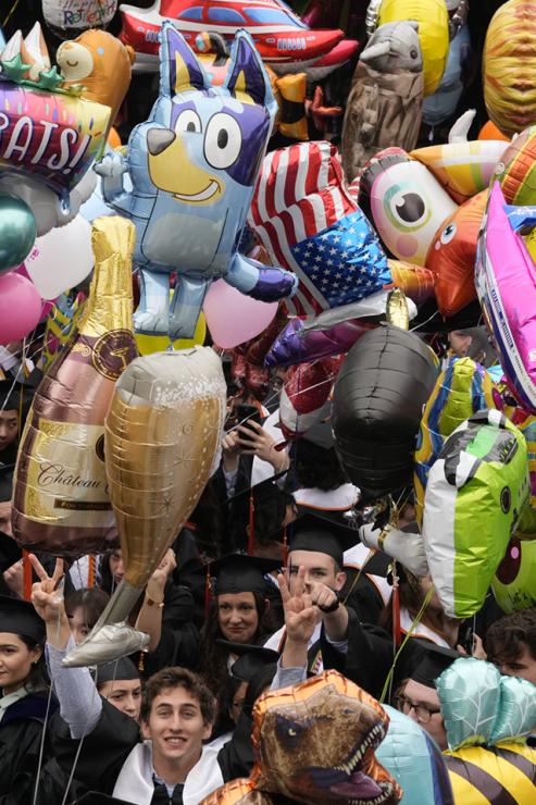 Students gather with a mass of balloons
